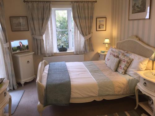 A bed or beds in a room at Copperfields Guest House 