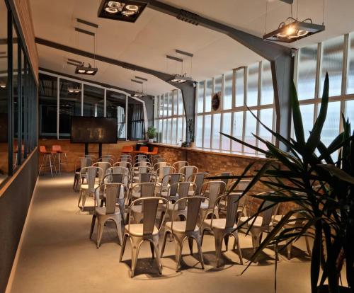 a room with a bunch of chairs and a table at Einzigartiges Industrie Loft Atelier in Bad Salzuflen