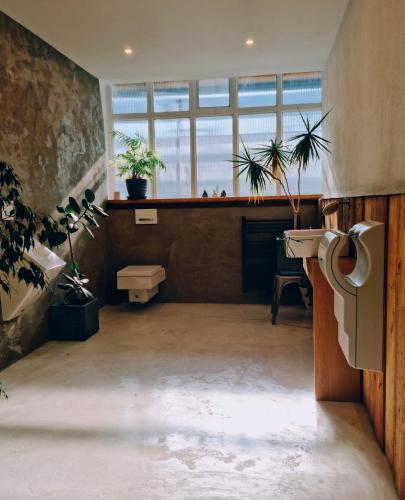 a bathroom with a sink and plants in a room at Einzigartiges Industrie Loft Atelier in Bad Salzuflen