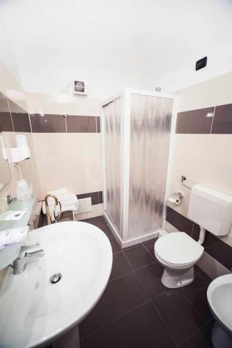a bathroom with a sink and a toilet and a shower at Hotel Principe in Casale Monferrato