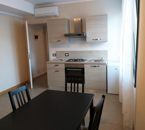 a kitchen and dining room with a table and chairs at Appartamenti la Piazzetta vicino a Firenze in Signa