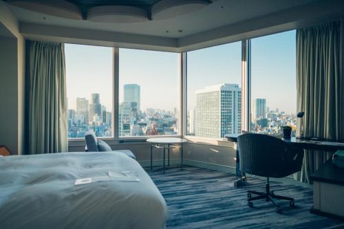 a hotel room with a bed and a desk and windows at The Prince Park Tower Tokyo - Preferred Hotels & Resorts, LVX Collection in Tokyo