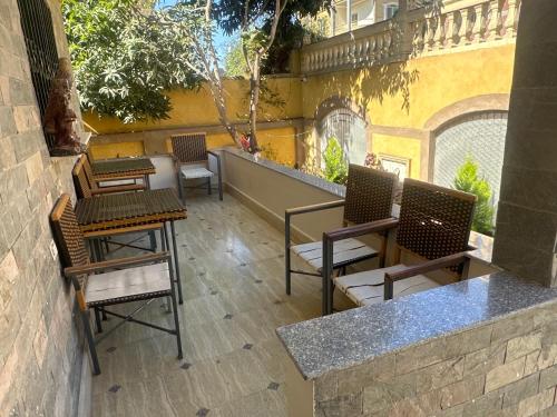 a group of chairs and tables on a patio at VIP villa Ali in Ismailia