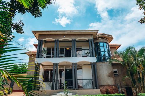 a large house with a balcony on top of it at Affordable Homely Apartment 2 in Namulanda