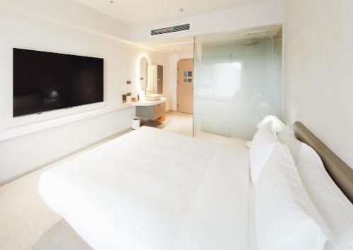 Ένα ή περισσότερα κρεβάτια σε δωμάτιο στο Qilidai Hotel