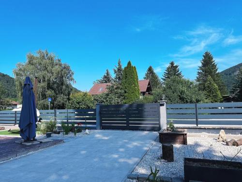 a patio with a umbrella and a fence at Up Residences in Baden