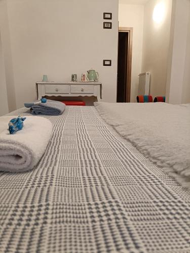 a bedroom with a large bed with white sheets at Casa Castegner - Rooms in Seren del Grappa
