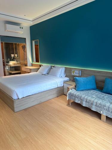 a bedroom with a large bed and a couch at Tam Coc Wonderland Lodge in Ninh Binh
