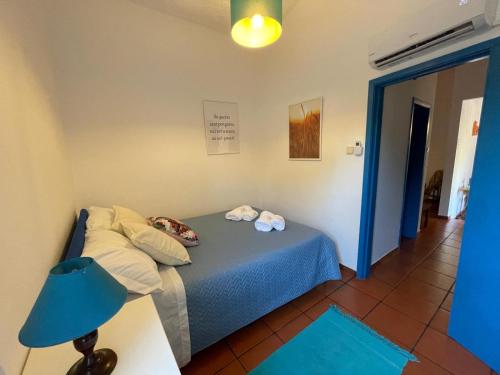 a bedroom with a bed and a blue lamp at Sweet Living Alentejo in Brinches