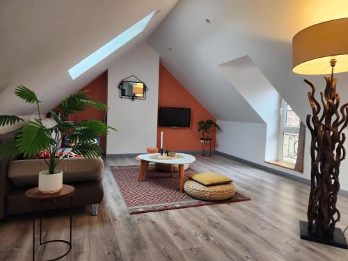 a living room with a couch and a table at Appartement calme Le clos de Renée in Hautvillers