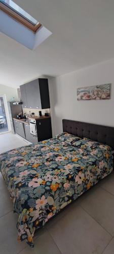 a bedroom with a bed with a floral bedspread at Tominettihome in Verbania