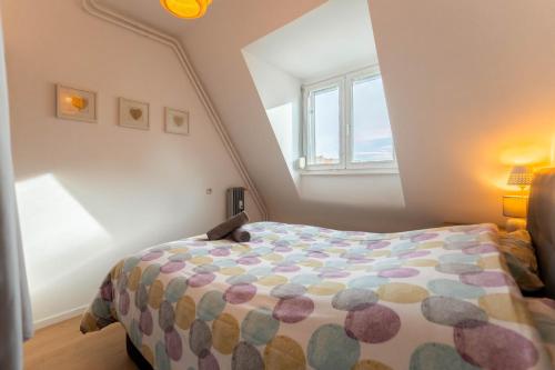 a bedroom with a bed and a window at Le 16 - Parking city center in Colmar