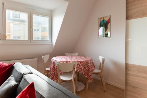 a small dining room with a table and chairs at Le 16 - Parking city center in Colmar