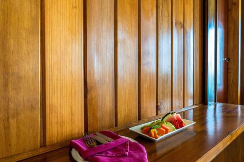 a table with a bowl of fruit and a plate of food at Insight Resort Ahangama - S&S Other Certified in Ahangama
