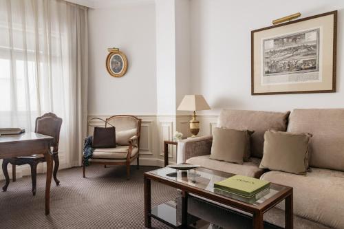 a living room with a couch and a table at Hotel Fenix Gran Meliá - The Leading Hotels of the World in Madrid