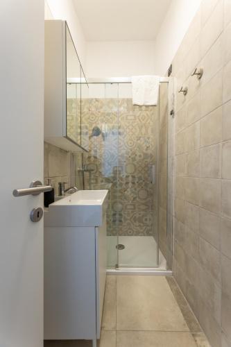 a bathroom with a shower and a sink and a toilet at Apartments Korta in Split