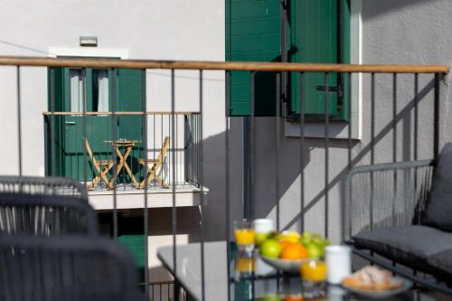 a table with a bowl of fruit on a balcony at Apartments Korta in Split