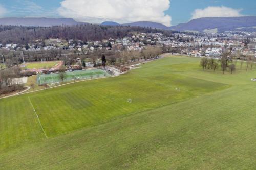 an aerial view of a golf course with a green field at Swissholiday in Woschnau