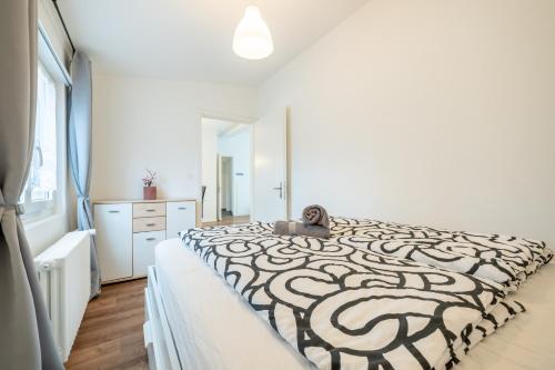 a white bedroom with a black and white bed at Swissholiday in Woschnau