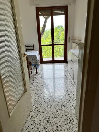 a kitchen with a door open to a kitchen with a counter at Gaia2 in São Lourenço