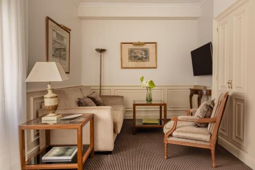 a living room with a couch and a table at Hotel Fenix Gran Meliá - The Leading Hotels of the World in Madrid