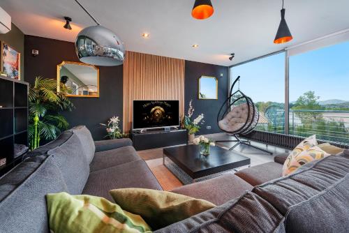 a living room with a couch and a fireplace at Villa Rockstar, Alcudia - by EMERALD STAY in Alcudia