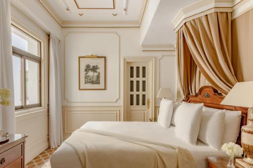 a bedroom with a white bed and a window at Hotel Fenix Gran Meliá - The Leading Hotels of the World in Madrid