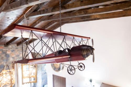 a wooden airplane chandelier hanging from a ceiling at Dandy Villas Palios Agios Athanasios - Attic - Fireplace - Village Square in Palaios Agios Athanasios