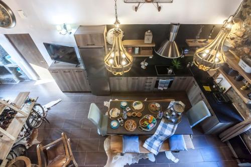 an overhead view of a kitchen with a table and lights at Dandy Villas Palios Agios Athanasios - Attic - Fireplace - Village Square in Palaios Agios Athanasios