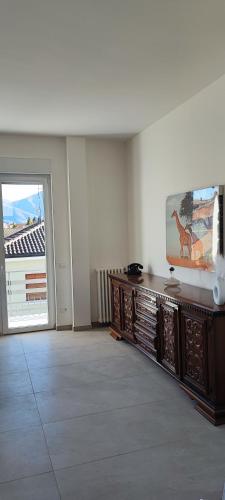 a living room with a tv on a wooden entertainment center at Tominettihome in Verbania