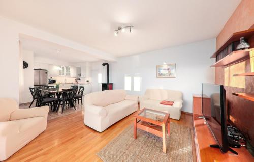 a living room with white furniture and a table at Five-Bedroom Holiday Home In Blato Na Cetini in Blato na Cetini