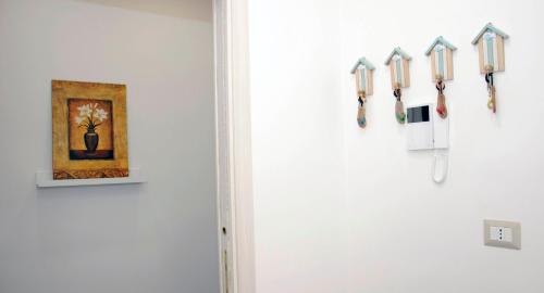a room with a white wall with a row of keys at Aurora B&B in Agropoli
