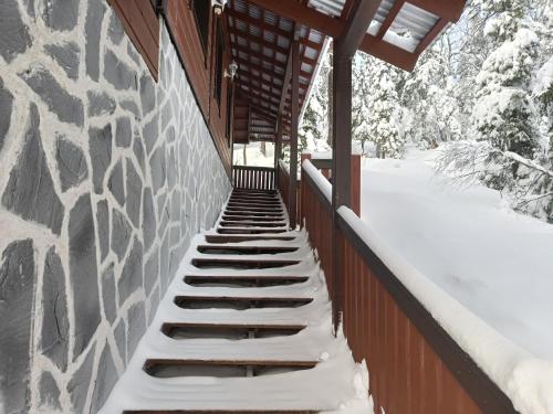 a snow covered staircase on the side of a building at Kärpänrinne B in Syöte