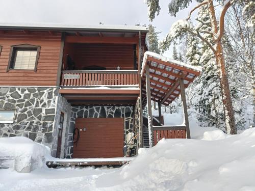 a cabin in the snow with a balcony at Kärpänrinne B in Syöte