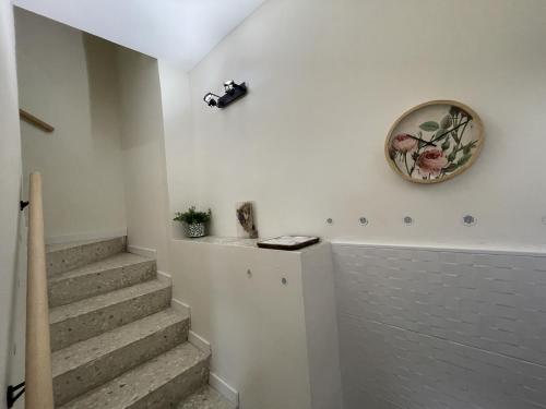 a bathroom with stairs and a clock on the wall at Casa Rural Renueva en Buendía in Buendía