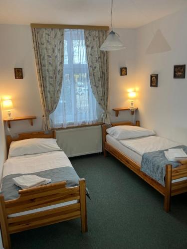 Postel nebo postele na pokoji v ubytování Pension Abbazia
