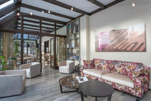 a living room with a couch and a table at Hotel im Auerbachtal in Bad Laasphe