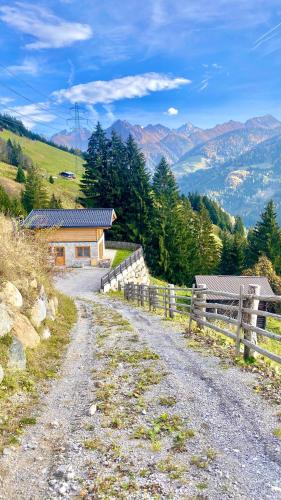 a dirt road leading to a house on a mountain at Wieslhütte in Gerlosberg