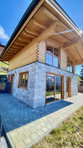 a house with a large patio in front of it at Wieslhütte in Gerlosberg