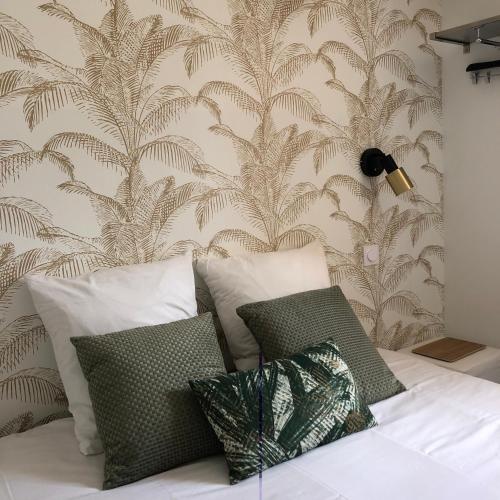 a bedroom with a bed with a wall mural at Logis Hôtel La Fenière in La Bouilladisse