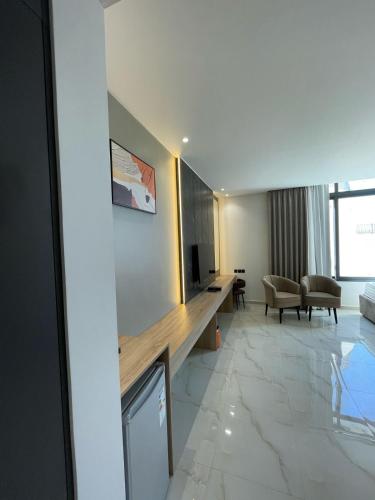 a hotel room with a television and a living room at Diamond Palm Hotel & Resort in Al Burj