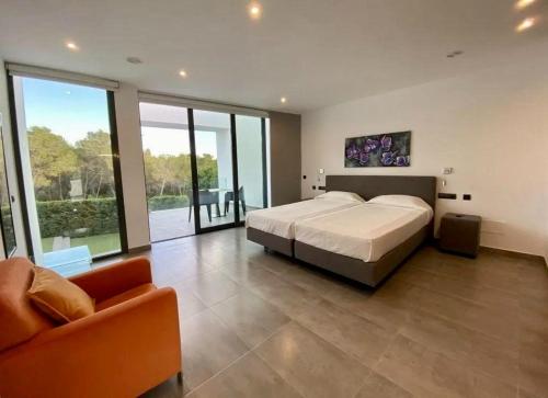 a large bedroom with a large bed and a couch at Villa Lux Mar in Cala Llena