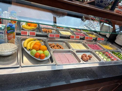 a display case in a store filled with fruits and vegetables at VIP Apartments in Bratislava
