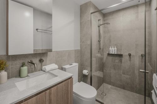 a bathroom with a shower and a toilet and a sink at "The Mowbray"-Luxury,rooftop pool,gym,free parking in Brisbane