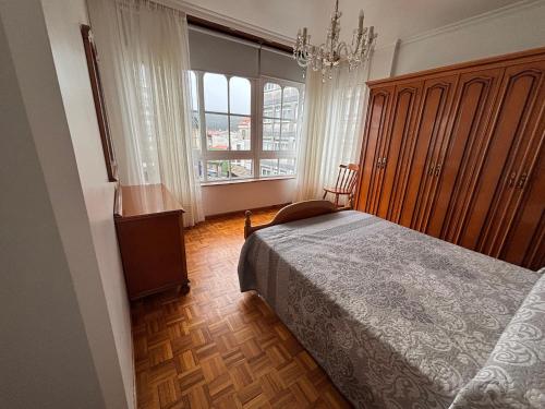 En eller flere senge i et værelse på Piso en Ribeira centro by Cristian&Tamara "alquileres"