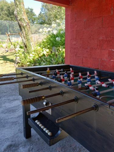 a wooden foosball table with at Coutada dos Pinheiros - Pinheiros Farm House in Fafe