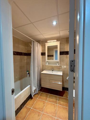 a bathroom with a tub and a sink and a mirror at Heavenly Homes Mojacar 4 in Mojácar