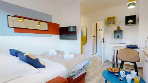 une chambre avec un lit et une table dedans dans l'établissement expat renting - Le Pop - Netflix - Proche gare, à Toulouse