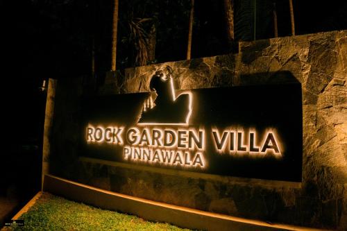 a sign for the rock garden villa at night at Rock Garden Villa Pinnawala in Rambukkana