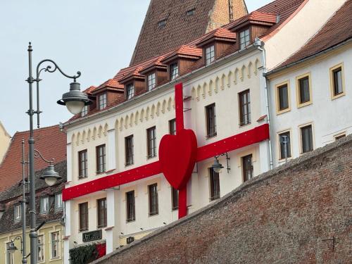 a building with a red heart on the side of it at ART Hotel in Sibiu